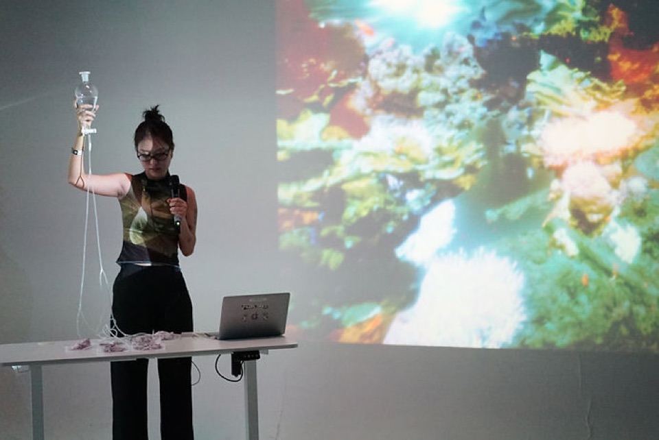 Ker Chen performing with a projected image