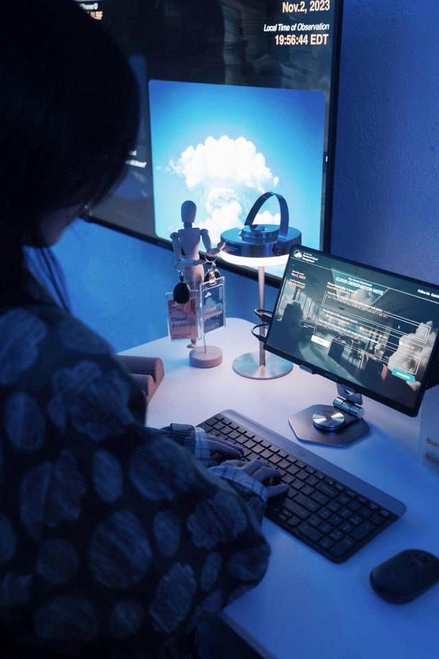 A visitor submitting a cloud memory at the Bureau of Cloud Management workstation, iidrr Gallery, New York, November 2023. Image courtesy of iidrr.